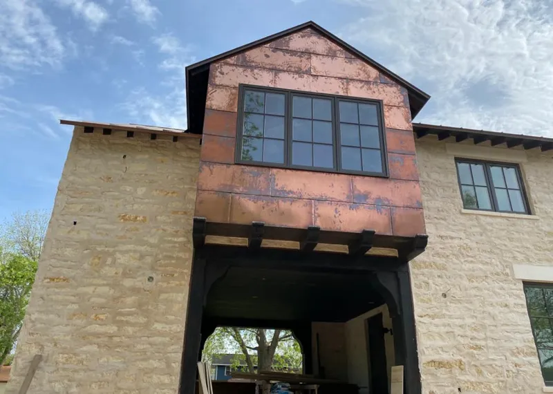 Copper metal panel facade on a stone building for Skylight Installation in White Marsh